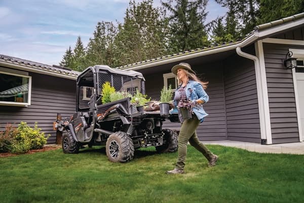 Woman unloading the cargo bed of RTV
