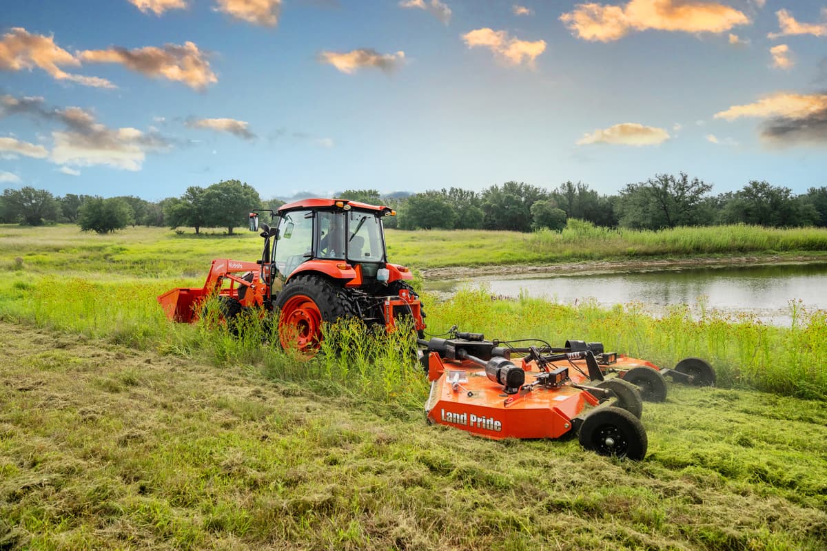 Kubota tractor pulling a Land Pride disc mower